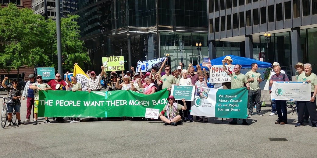 Group with banner saying The people want their money back